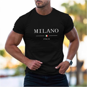 Man wearing black Milano print shirt with white shorts at beach bar